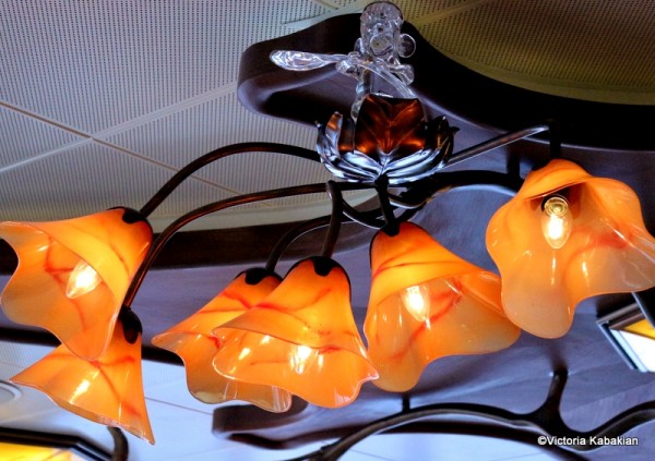 Remy atop one of the lighting chandeliers