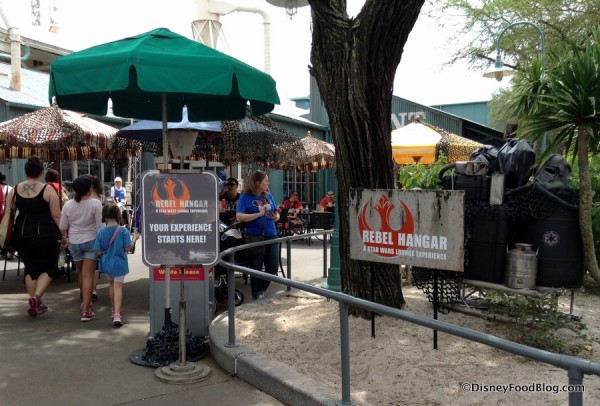 Outdoor tabletops and entrance to Rebel Hangar