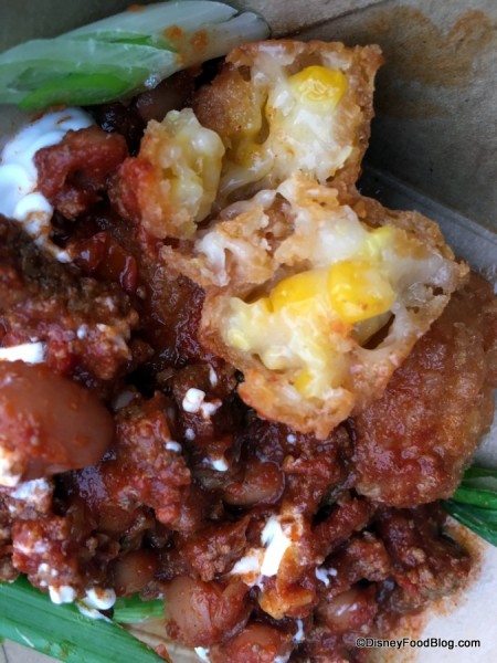Sweet corn nuggets with beef chili, spring onions and sour cream