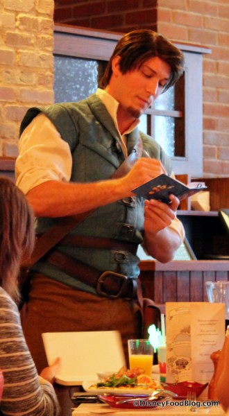 Flynn Rider signing autographs