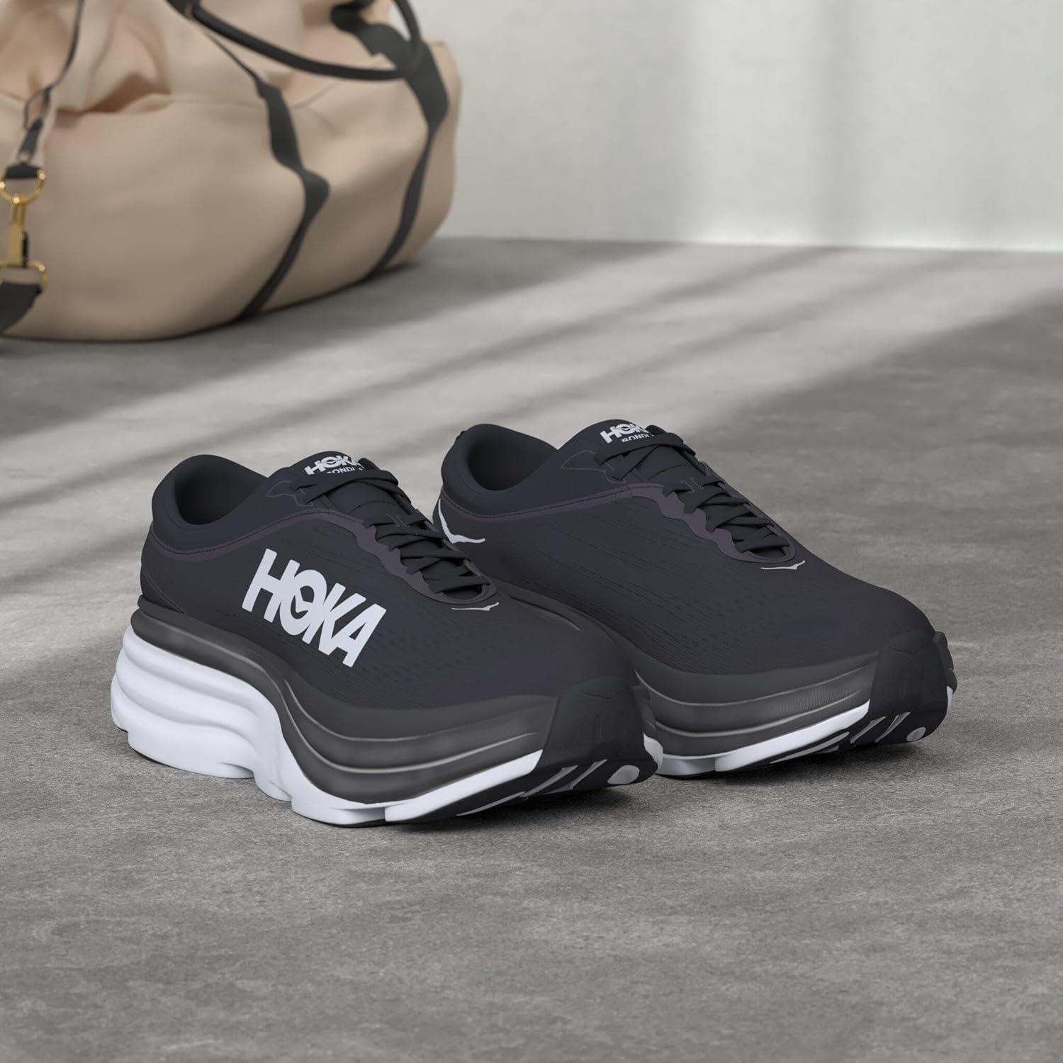 A pair of Hoka One One men's running shoes in a sleek black and white design, featuring the Hoka brand name prominently displayed.