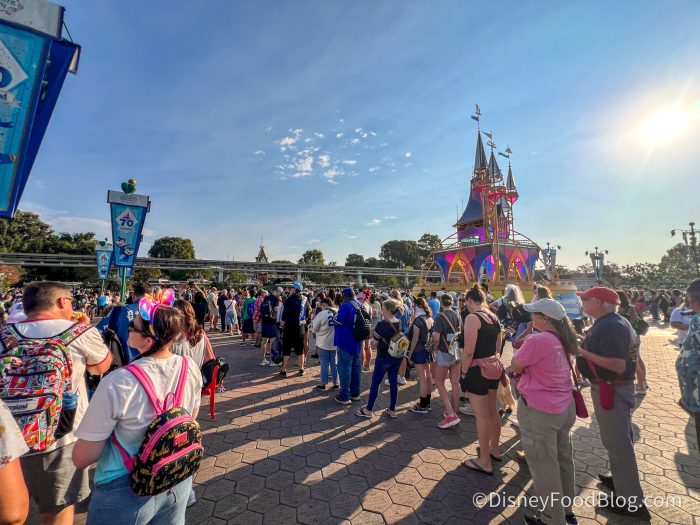 crowds in the sun with a sign for 70th anniversary in the corner